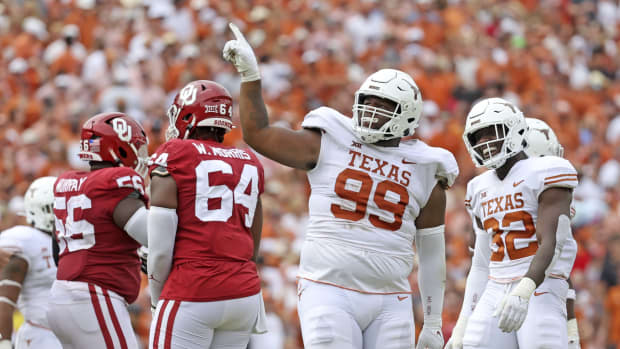 Texas defensive lineman Keondre Coburn reacts to tackle